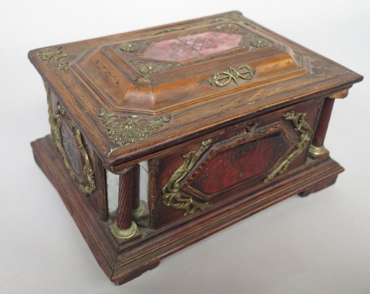 ANTIQUE CONTINENTAL JEWEL CASKET: Walnut with mirrored canted corners and twisted glass columns, etched glass floral panels, and foliate bronze mounts. Hinged top with mirror, raised on bracket feet. 11 x 7 x 8.5." Worn finish, crack 