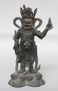 CHINESE BRONZE WARRIOR FIGURE: Wearing armor and holding weapons, with a gilt face. H. 13." Loss to part of crest.