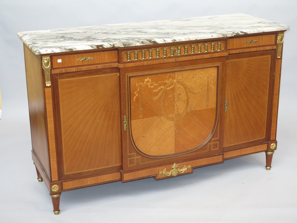 BUFFET CABINET: A Louis xvi style marble top and bronze mounted satinwood marquetry walnut Buffet cabinet. The beveled block front rectangular white and rouge marble top above triple cabinet doors. The whole raised o