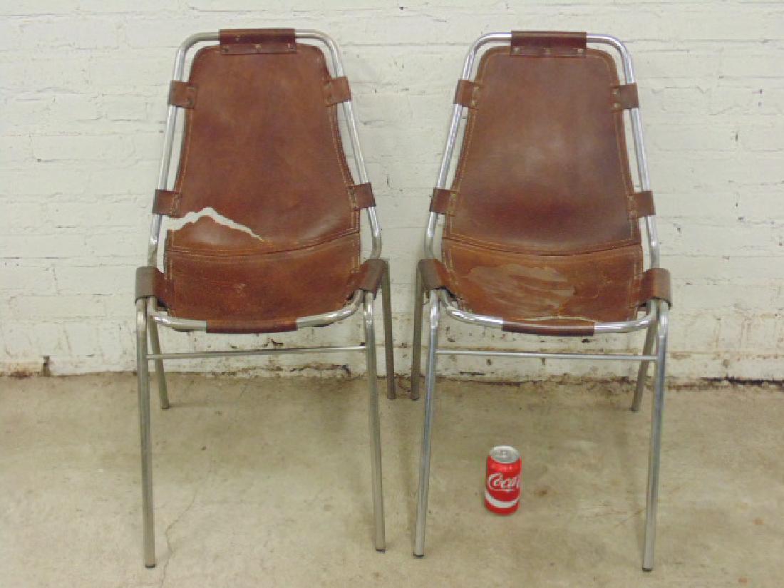 Pair Charlotte Perriand "Les Arcs" side chairs: Pair of Charlotte Perriand "Les Arcs steel & leather side chairs, leather ripped, chairs are 20" wide, 14" deep, height is 32"