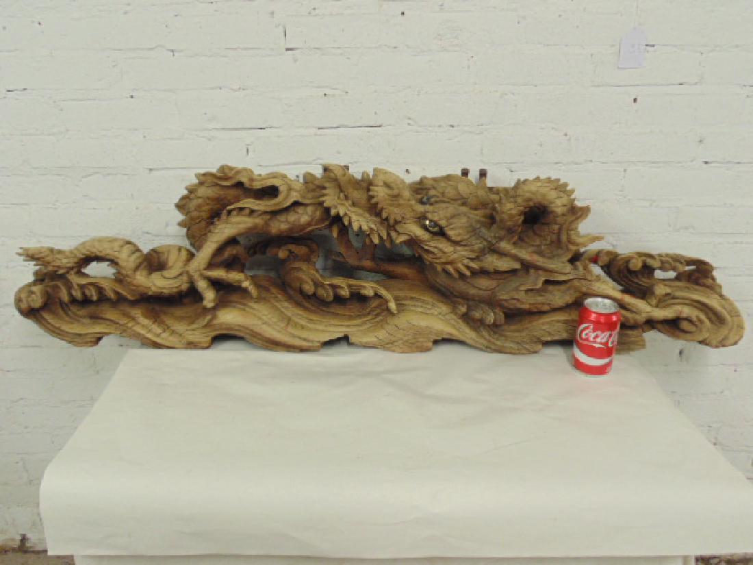 Antique Japanese carved wood temple dragon: A Japanese Temple Dragon Carving, carved wood with inset glass eyes. Dragon is 54" long, old iron mounds. Please refer to images for additional information regarding condition issues, please remember 