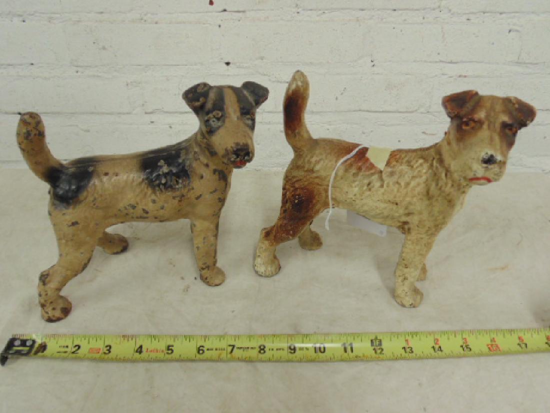 2 cast iron dog doorstops, terriers: 2 Terrier Dog Cast Iron Doorstops, original paint. Some chips on paint, wear consistent with age. Please refer to images for additional information regarding condition issues, please remember all item