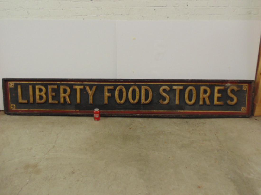 Country sign, "Liberty Food Stores", gilt raised: Country sign, "Liberty Food Stores", gilt raised letters on black field, red trim, sign is 108.25" long, 16.25" tall. All items sold as is, all sales final, contact us if you need more information, by
