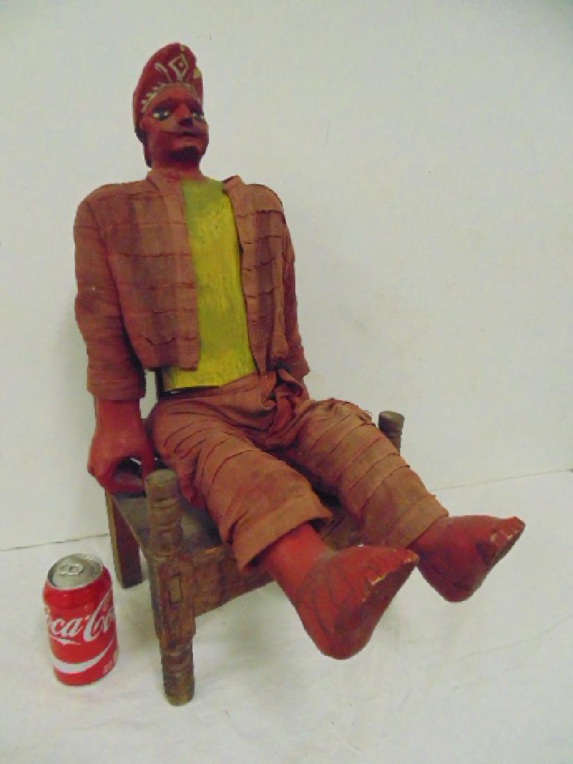 Latin American folk art carved wood anatomical figure: Mexican, Latin American folk art carved wood anatomical figure of man with moustache & hat seated in chair, red painted face, feet & hands, red clothes, height, seated is 24"