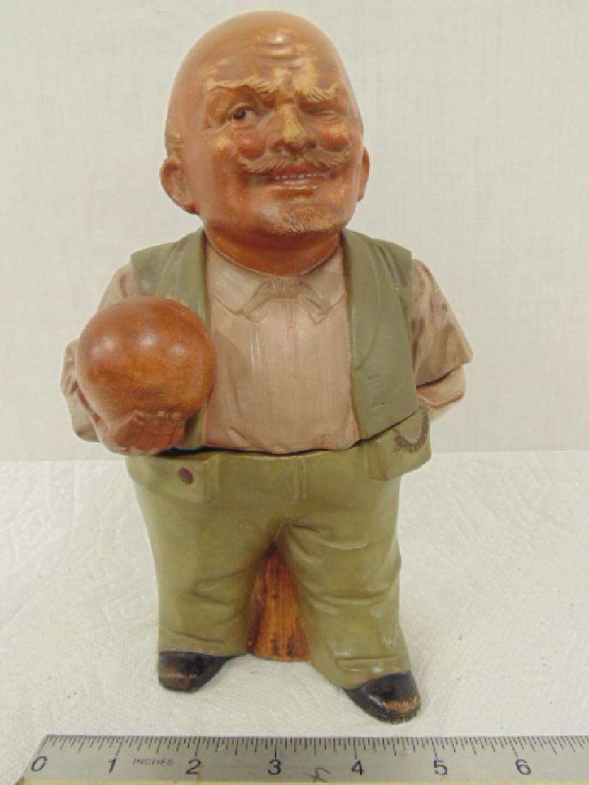 Tobacco jar, Humidor, figural, bald man with ball: Tobacco jar, Humidor, figural, bald man with ball (bowling) squinting his eye, numbered on rear, otherwise unmarked, height is 9.25", in good condition