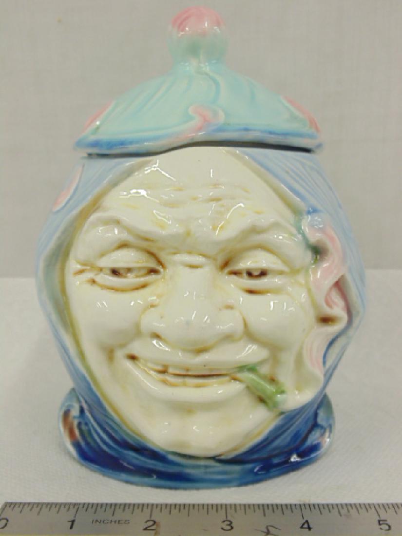 Majolica Tobacco humidor, man with cigarette, clown hat: Majolica Tobacco jar, humidor, man with cigarette in clown type headdress, in good condition, height is 7"