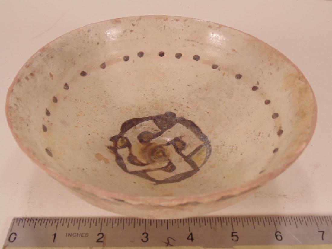 Nishapur Islamic Ceramic Bowl, 900-1000 AD, decorated: Nishapur Islamic Ceramic Bowl, 900-1000 AD, decorated in center with brown black swastika symbol & waveform pattern over a cream slip-ware, height is 2.5", diameter is 6.75", intact, un-restored condi