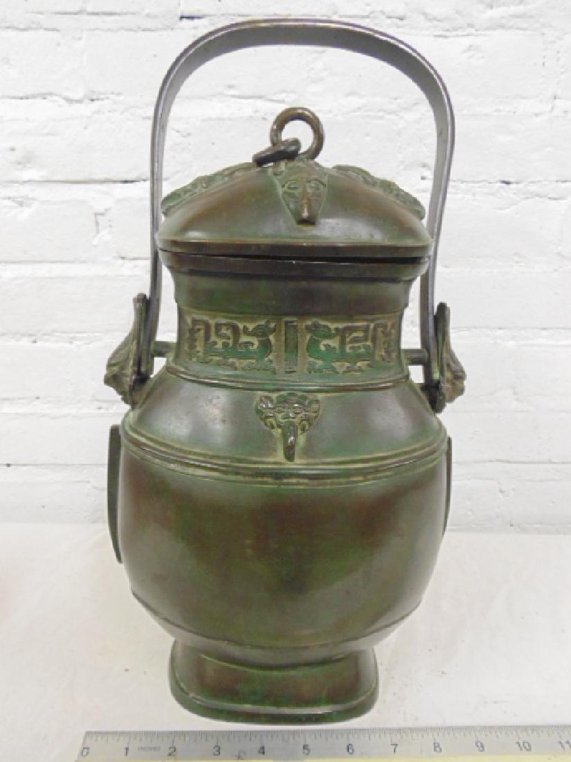 Ming Dynasty bronze Yu or wine vessel with cover & loop: Ming Dynasty bronze Yu or wine vessel with cover & loop handles, nice patina, Period Wan Li, Ming Dynasty, height is 13.75" (excluding handle). please refer to images for additional general condition 