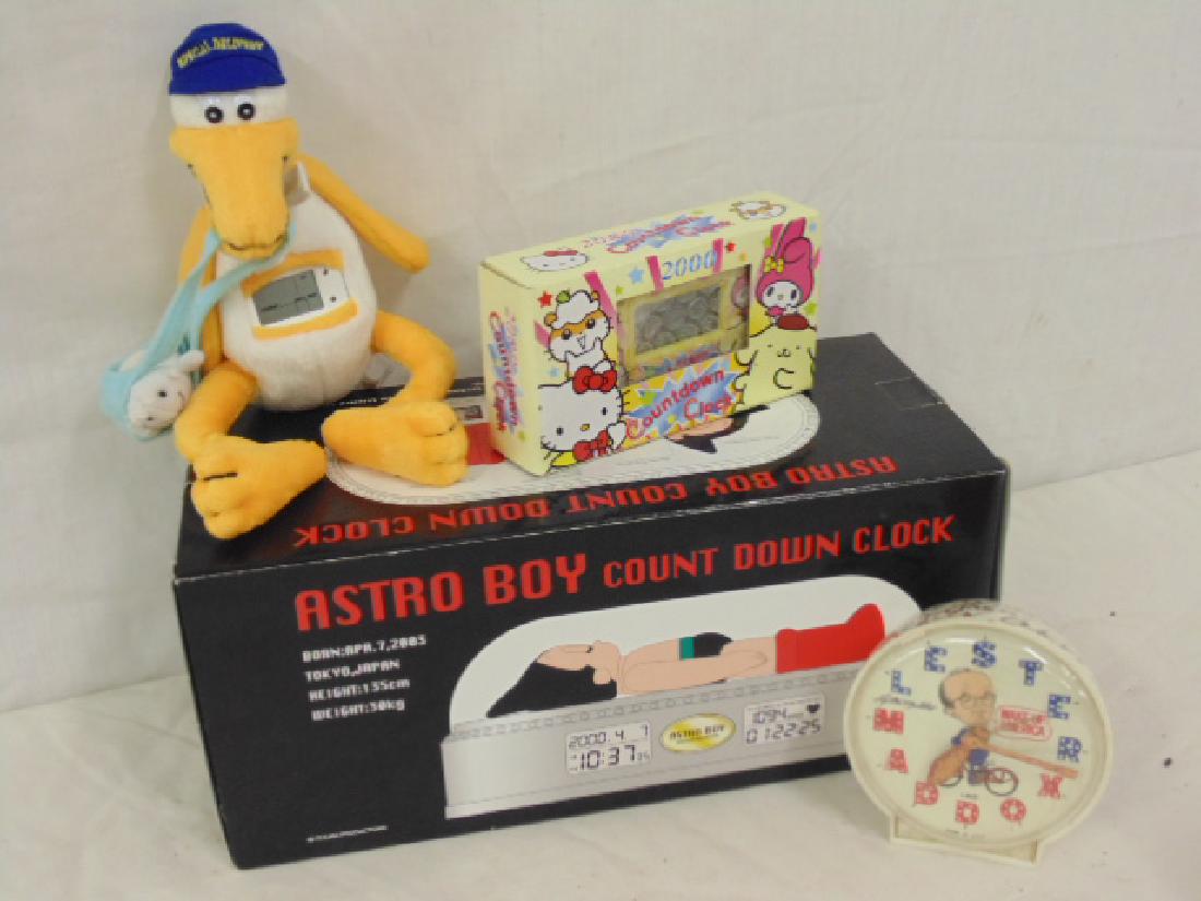 Figural clock lot, "Hello Kitty" 2000 Countdown Clock: Figural clock lot, "Hello Kitty" 2000 Countdown Clock in original box, "Astro Boy" Countdown clock in original box, Stuffed "Express Delivery" maternity plush with digital build in clock by Fiesta & L