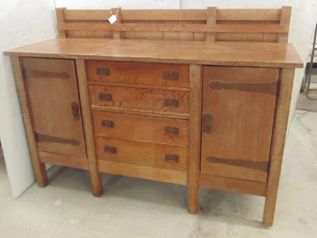 Gustav Stickley #817 sideboard, 8 legs, plate rack, 4: Gustav Stickley #817 sideboard, 8 legs, plate rack, 4 drawer center flanked by two doors with strap hinges, cabinet is 70" by 25.25" by 50.5" good condition needs finish restoration