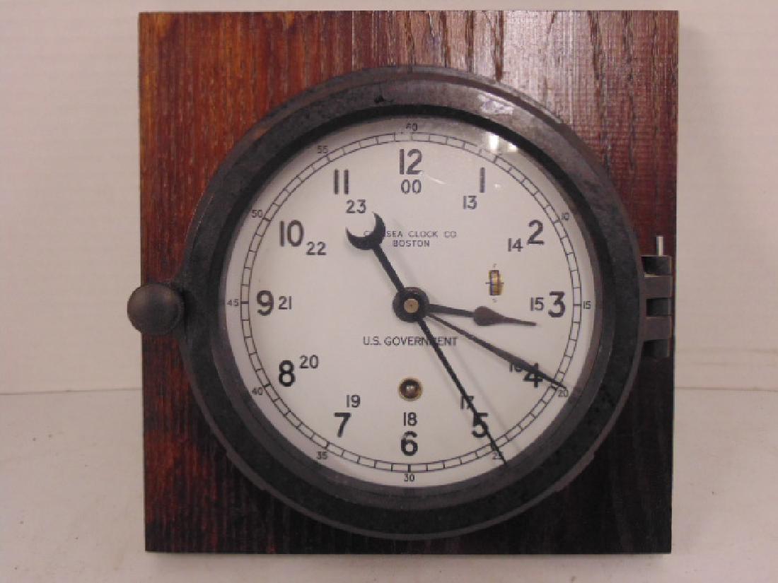 Chelsea clock Company Nautical clock, U.S. Government,: Chelsea clock Company Nautical clock, U.S. Government, Bakelite, or hard plastic case, mounted on wood board, diameter is 6.5", with key