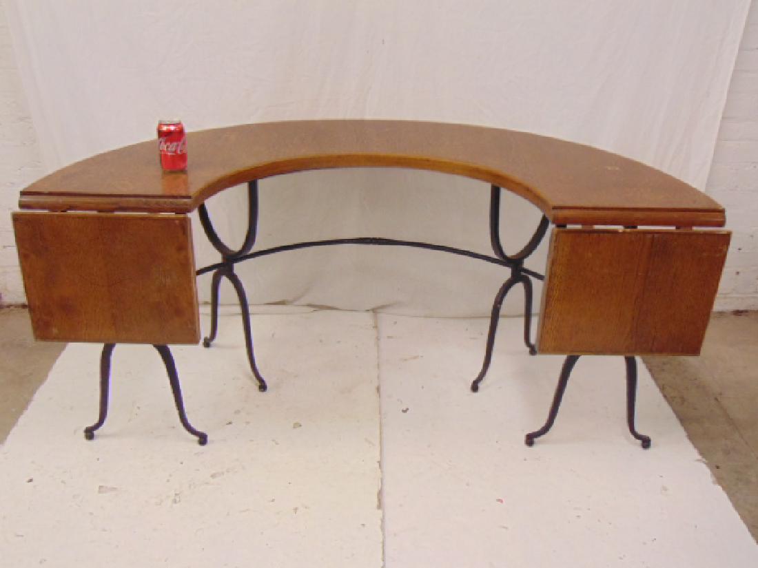 Oak top iron base half moon table with drop leaf ends,: Oak top iron base half moon table with drop leaf ends, curved top oak table with decorative wrought iron base, table is 63" wide, 33" deep with leaves down, height is 28"