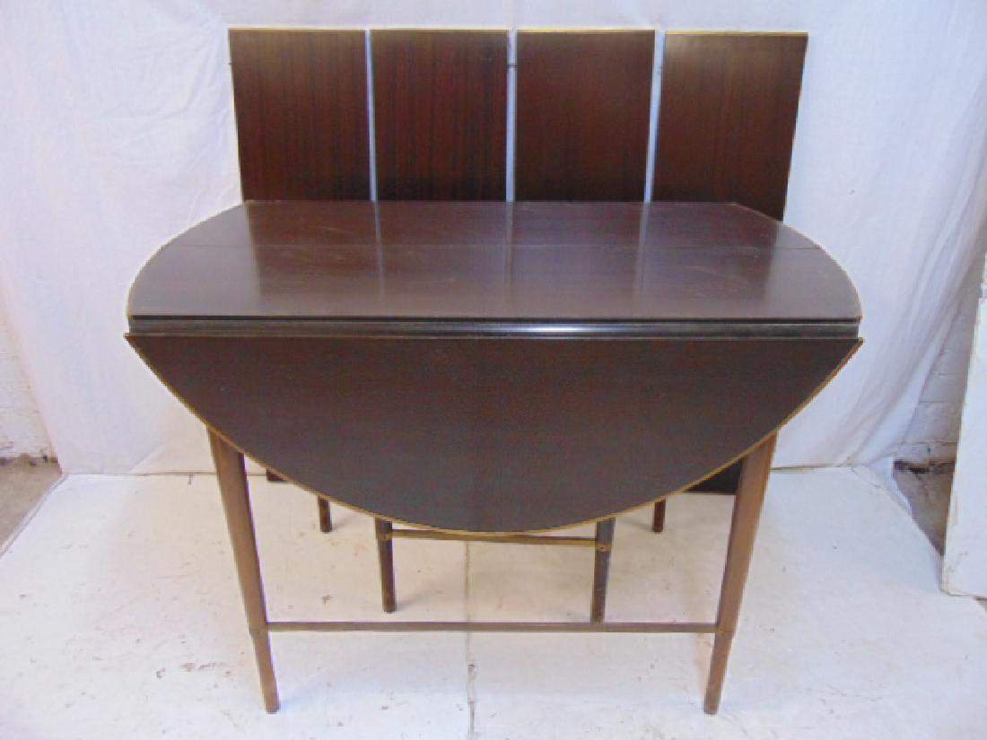 Paul McCobb, Calvin dining table, drop leaf dining: Paul McCobb, Calvin dining table, drop leaf dining table with solid brass trim, table comes with 4 11" leaves & pads, brass trim on table loose, 4 pieces of brass trim on leaves are missing, table has