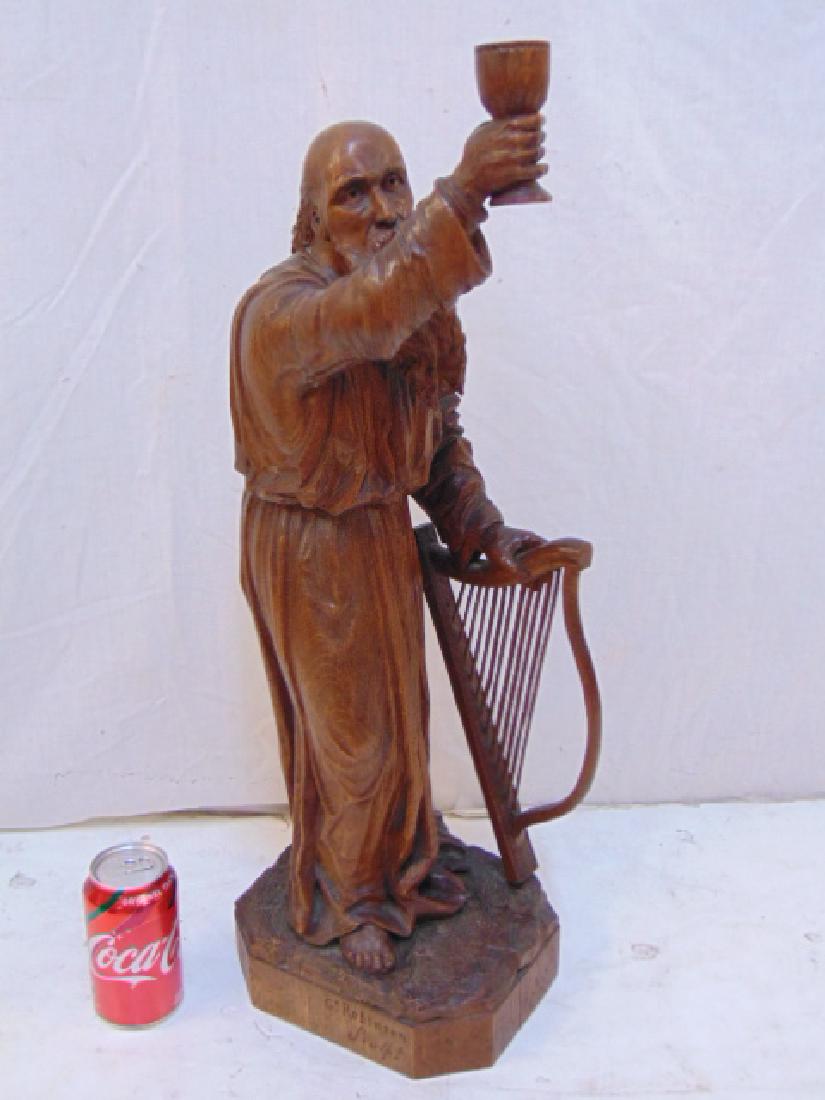 Woodcarving, St. Patrick, Gd. Robinson, Sculpt. carved: Woodcarving, St. Patrick, Gd. Robinson, Sculpt. carved wood sculpture of Saint Patrick holding cup & leaning on harp, height is 25.25", signed.