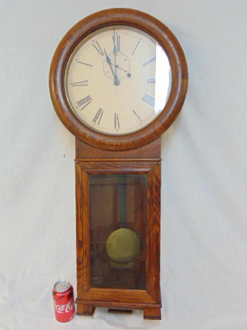 Oak regulator wall clock, 36" tall, case has been: Oak regulator wall clock, 36" tall, case has been repaired, corner door reglued, back is loose