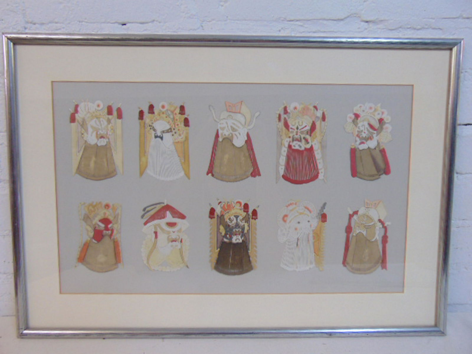Collage Japanese ceremonial masks, fine paper cut out: Collage Japanese ceremonial masks, fine paper cut out masks applied to paper backing showing 10 ceremonial masks, size is 11.25" by 18.75", excluding matting.
