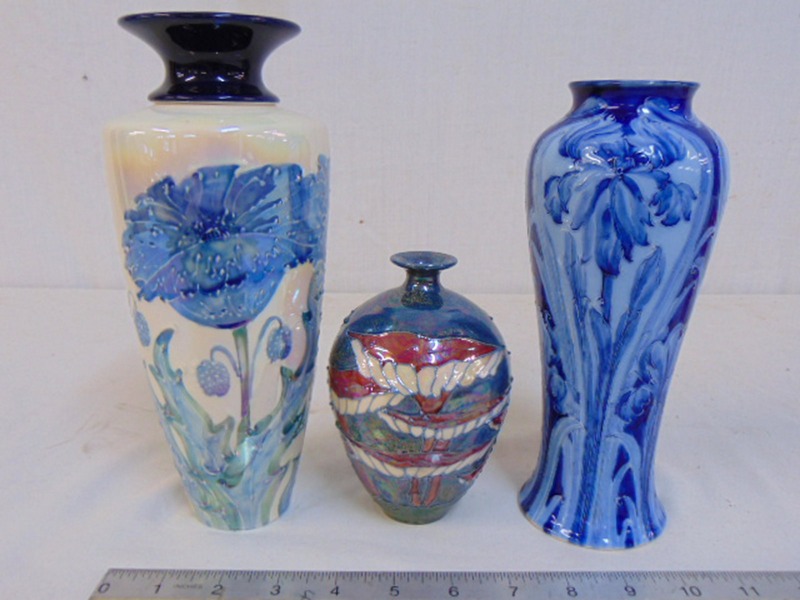 3 vases, Lise Moorcroft, Florian Ware, Moorland: 3 vases, Lise Moorcroft, Florian Ware, Moorland Staffordshire, all floral decorated, Moorland Staffordshire Chelsea works, Burslem vase with blue floral decoration is 9.25" tall, Moorcroft Florian vas