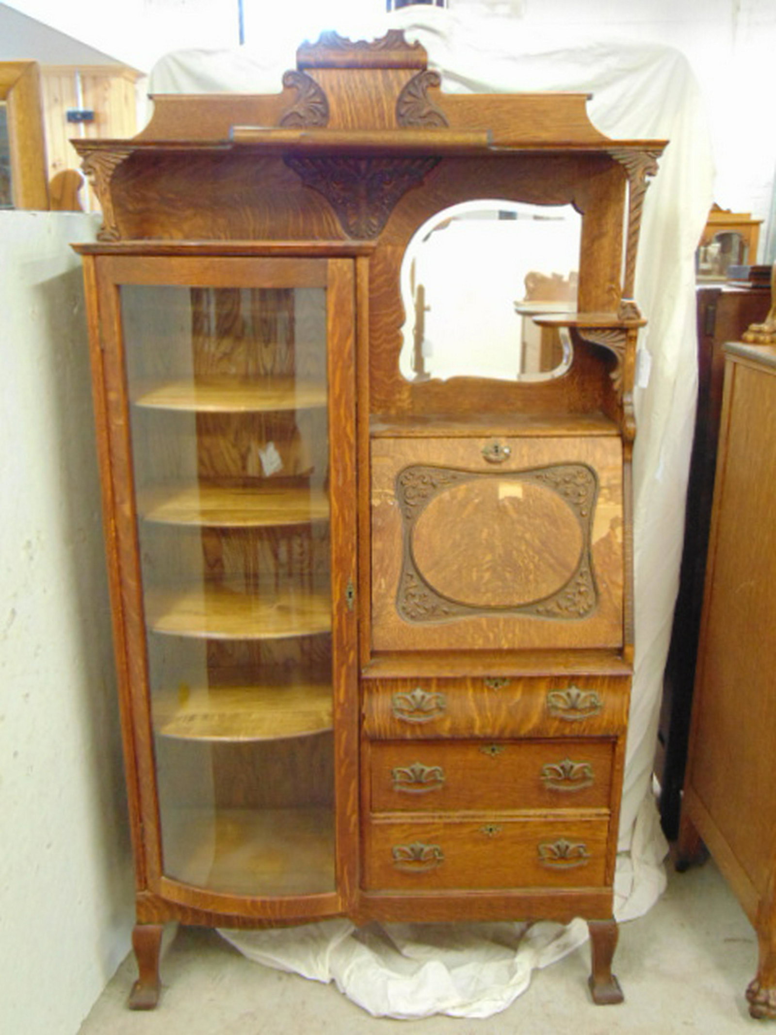Oak side by side, slant desk, curio combination, carved: Oak side by side, slant desk, curio combination, carved detail, original hardware, side by side is 39.5" wide, 13" deep & 72" tall, veneer damage to desk lid.