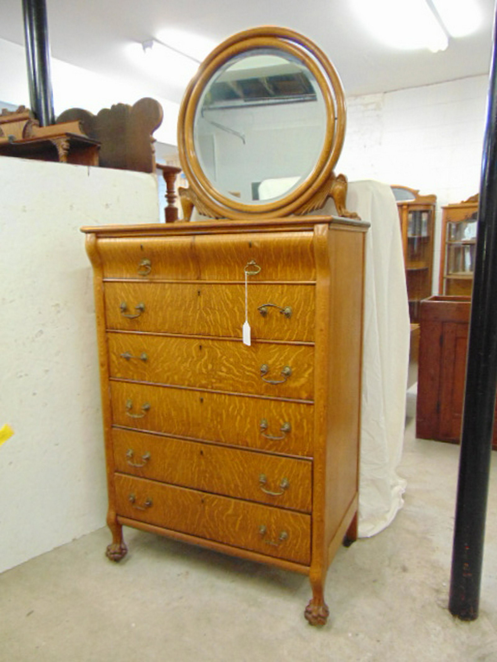 Oak chest with mirror, tall 2 over 5 oak chest of: Oak chest with mirror, tall 2 over 5 oak chest of drawers with round beveled mirror top, nicely carved harp with paws & wings, size, including mirror is 34.25" by 20.5", height is 77.25"