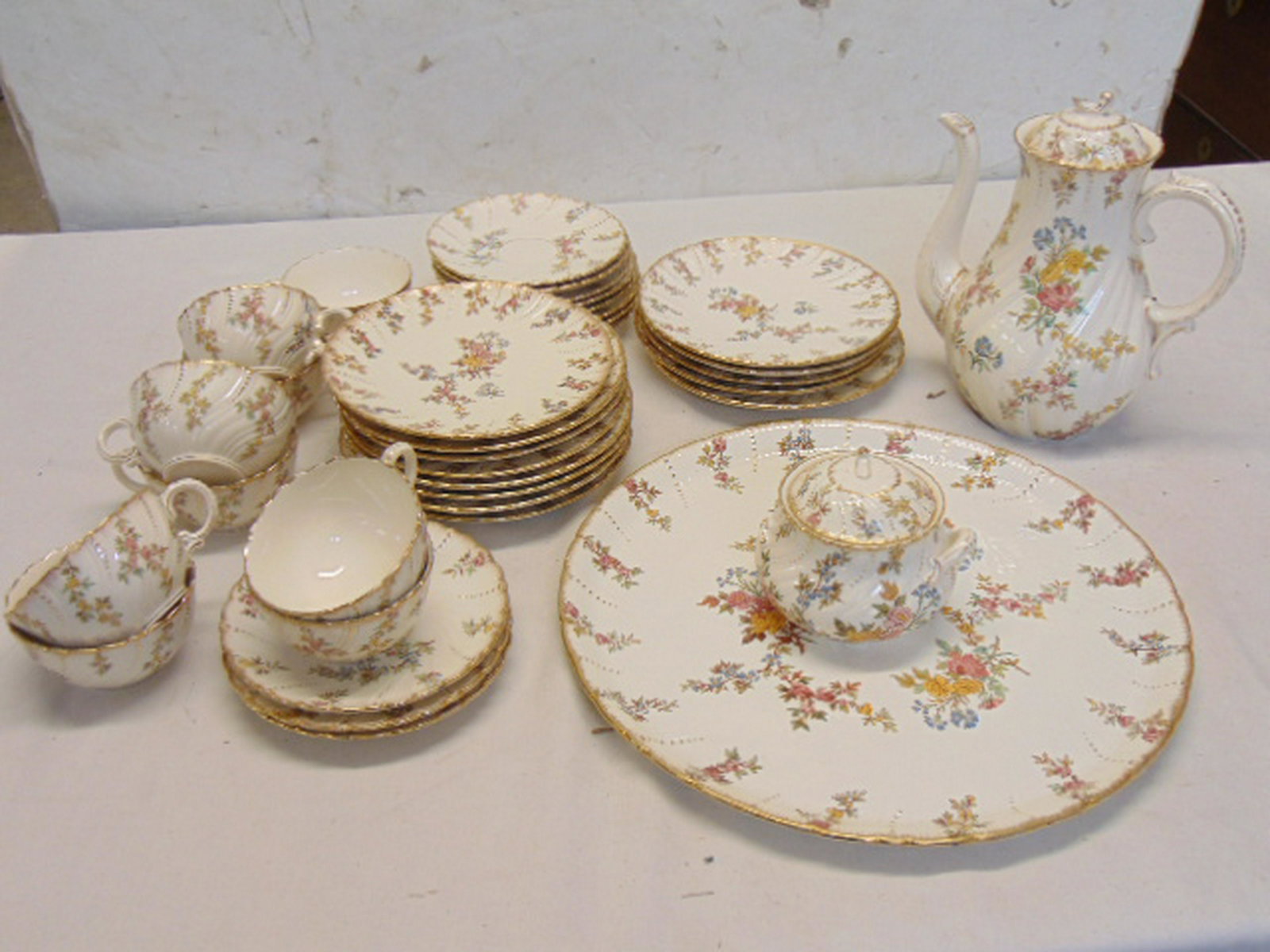 Partial set of Sarreguemines porcelain dinnerware, 13: Partial set of Sarreguemines porcelain dinnerware, 13 salad plates, sugar, teapot, 9 cups, 11 saucers & platter, finial on lid tea pot is broken.