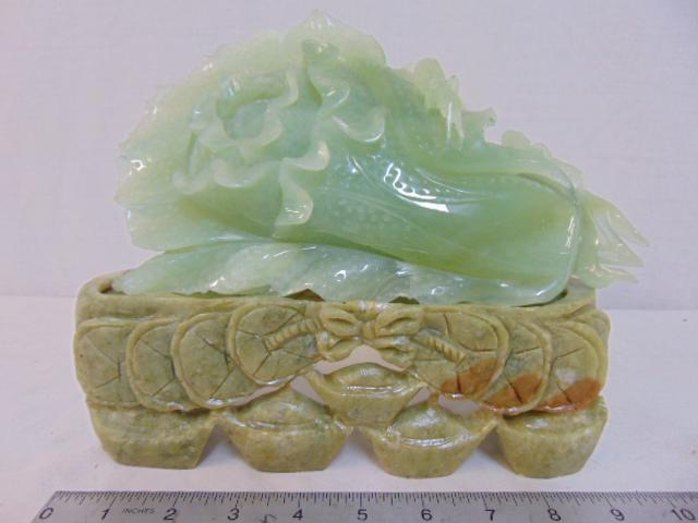 Jade carving, grasshoppers on cabbage, on carved: Jade carving, grasshoppers on cabbage, on carved soapstone base, has chip upper edge, 10" wide, 8.25" tall (incl. base) & 4" deep.