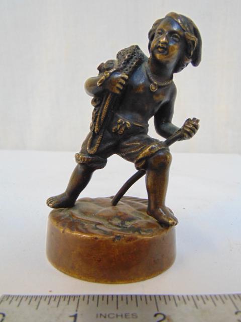 Bronze boy with net, Grueby pottery mark, unusual: Bronze boy with net, Grueby pottery mark, unusual bronze figure of a boy carrying a fishing net, base of bronze shows the Grueby pottery mark, height is 4"