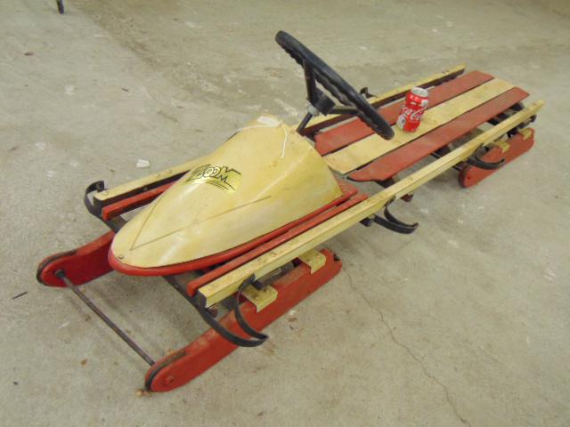 Vintage sled, 3 seater with steering, in red & white,: Vintage sled, 3 seater with steering, in red & white, "Zoom" sticker on nose, sled is 71" long.