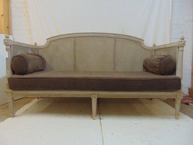 French caned box sofa, in grey paint, with brown: French caned box sofa, in grey paint, with brown pillows, sofa is 74" long, 31" deep & 43" tall.