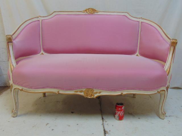 Pink upholstered loveseat, carved frame in white paint: Pink upholstered loveseat, carved frame in white paint with gilt detail, loveseat is 52" by 22", height is 35"