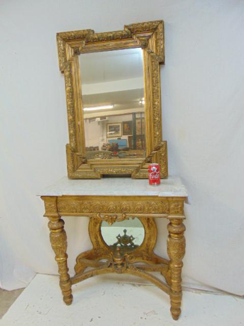 Marble top, gilt wood base hall table with mirrored: Marble top, gilt wood base hall table with mirrored back, 34" wide, 14" deep & height is 32.5", nicely carved detail