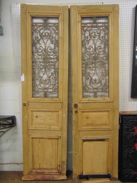 Pair decorative wood & iron doors, ex Bunny Williams: Pair decorative wood & iron doors, ex Bunny Williams estate, each door is 25" wide, height is 8 feet, one has loose bottom, some molding missing.