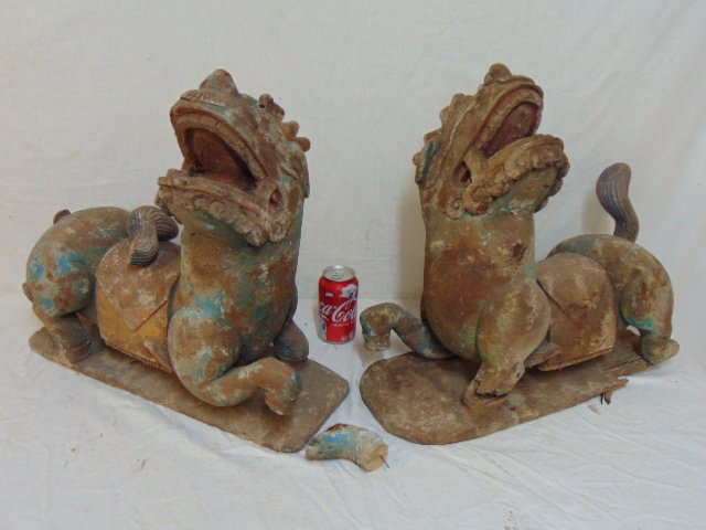 Pair carved Asian wood foo dogs or dragons: Pair carved Asian wood foo dogs or dragons, some old paint, as found, tail, feet loose, missing, need repair, each is 19.75" by 7.5", height is 18.75"