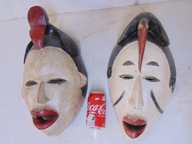 2 paint decorated African masks, carved wood, faces are (1 of 6)