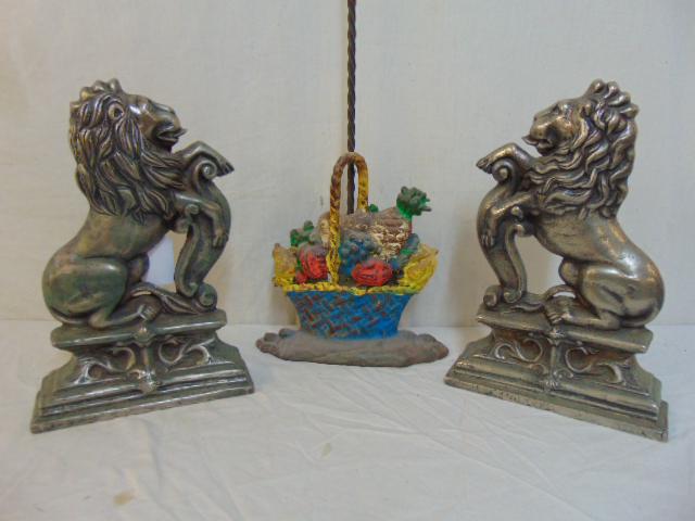 Pair polished iron lion chenets & floral doorstop, pair: Pair polished iron lion chenets & floral doorstop, pair lion chenets, 14.25" tall, 19th Century & floral basket iron doorstop, with handle.