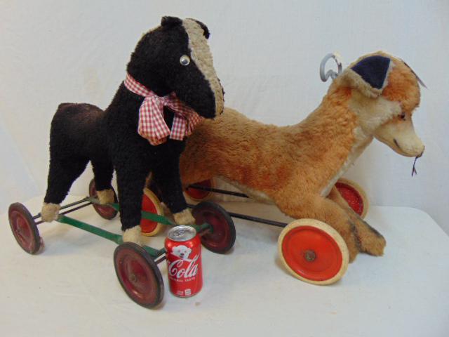 2 vintage toy riding animals, Steiff & other, Fox: 2 vintage toy riding animals, Steiff & other, Fox riding toy, with button in ear on metal base with wheels & black & white horse on wheels.