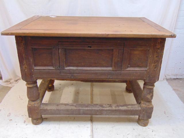 18th Century table with storage compartment, raised: 18th Century table with storage compartment, raised panel sides, stretcher base, base stretchers have old bug damage (see images), front has access panel that has been shut closed, top is 47" by 31.5"