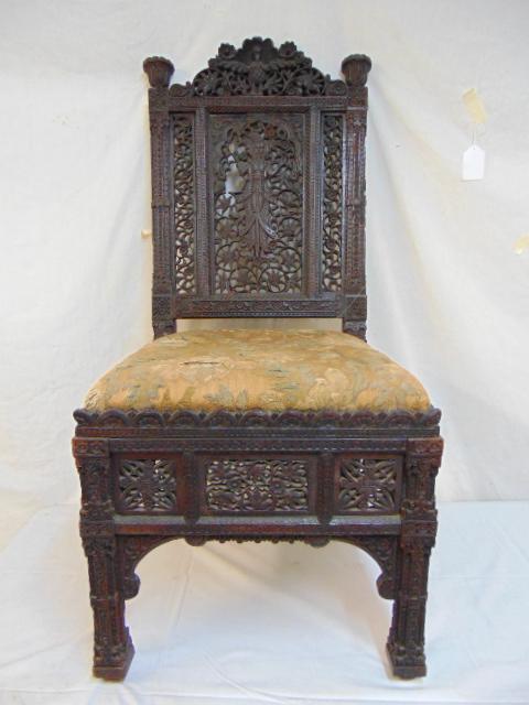 India craft revival chair, manner of Lockwood De: India craft revival chair, manner of Lockwood De Forest, elaborately carved teak side chair, carved back, legs, original upholstery, chair is 18" deep, 18.5" wide, height is 40.5", some damage, loss t