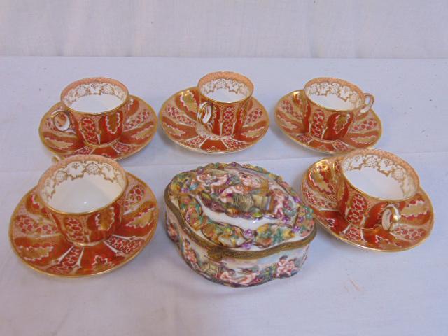 Capodimonte powder box & 5 Davenport cups & saucers,: Capodimonte powder box & 5 Davenport cups & saucers, box as is, cracked, glued lid, 5 red & white cups & saucers with gilt detail, Davenport, Longport Staffordshire.Update: Found a hairline in one of