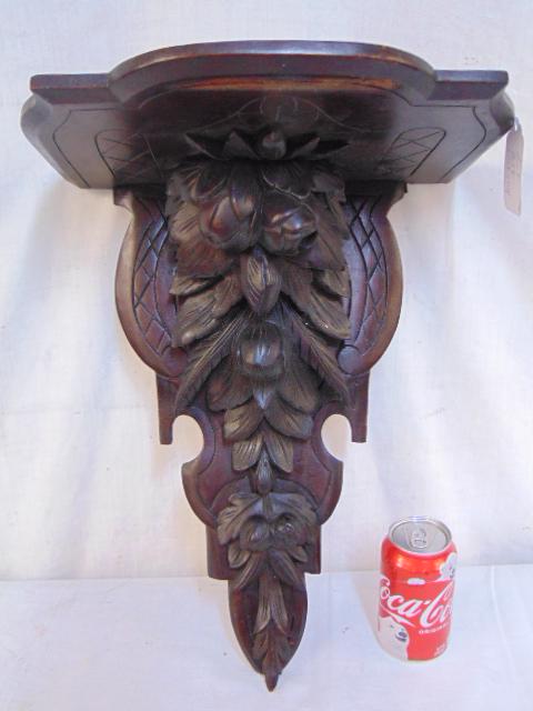 Carved black forest clock shelf, top shelf is 14.25" by: Carved black forest clock shelf, top shelf is 14.25" by 10.25", height is 18", small piece of carving is missing.