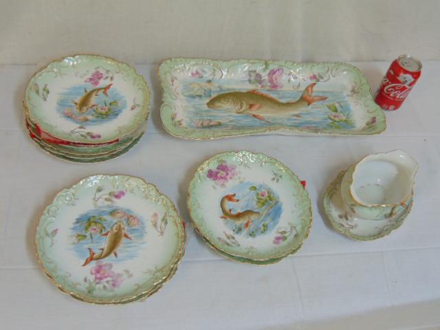 Porcelain dinnerware fish set, unmarked, 10 fish: Porcelain dinnerware fish set, unmarked, 10 fish decorated plates, 9", large serving platter, 19" by 9" & gravy boat, good condition.