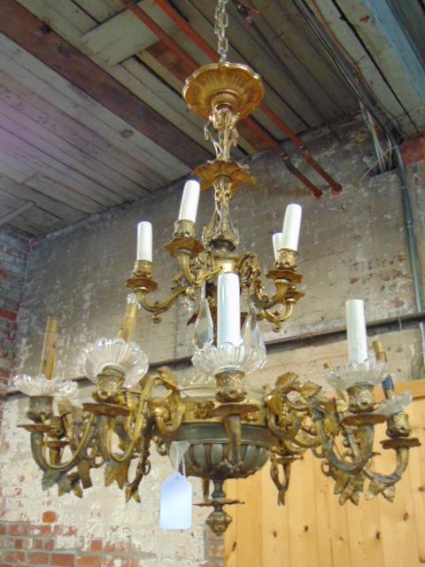 Gothic revival bronze hanging fixture, decorated with: Gothic revival bronze hanging fixture, decorated with grapes, leaves, two tier, lower tier has 10 arms, upper tier has 5 armas, with glass cups, crystals, fixture is in as found condition, some arms b