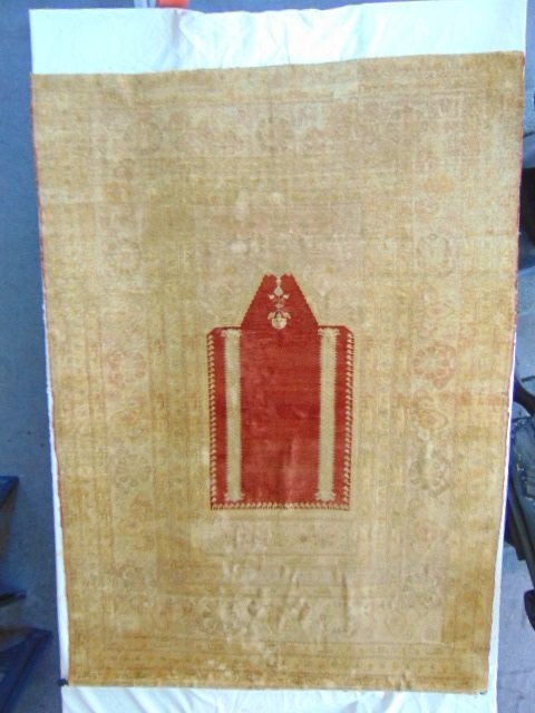 Antique silk Persian prayer rug, gold toned: Antique Persian silk prayer rug, gold toned with red center, faded floral decorations, fine made quality, was found hanging in a Hastings estate, backed on linen.NOTE, carpet is extremely brittle & dr