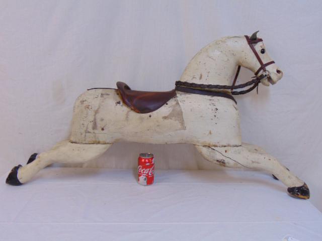 Carved wood horse, leather saddle, horse is 45" by 24",: Carved wood horse, leather saddle, horse is 45" by 24", repair to leg