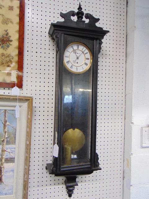 Regulator wall clock, black case, single weight,: Regulator wall clock, black case, single weight, pendulum, with second hand, clock is 45" tall, crest has been repaired, clock sold as is