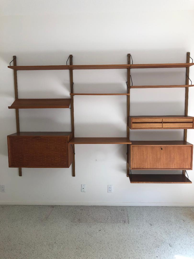 MCM wall unit, Danish, includes drop front cabinet with: MCM wall unit, Danish, includes drop front cabinet with basket weave front, 8 shelves, drop front cabinet with cubby interior (key) & 2 drawer unit, comes with 4 rails, each rail is 69", components ar