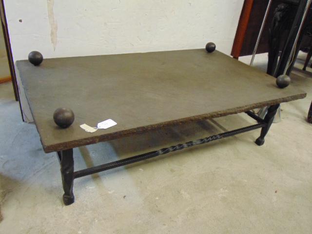 Slate top, iron base coffee table, with large round: Slate top, iron base coffee table, with large round ball shaped finials, top is 50.5" by 30.25", height is 14.5"