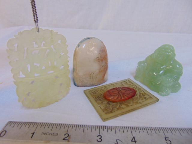 4 small Jade & stone carvings, includes small light: 4 small Jade & stone carvings, includes small light green Buddha figure; seal with inscribed calligraphy; carved Jade pendant & square jade carving with Carnelian decoration.