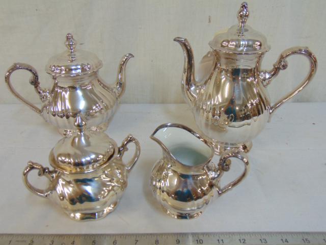 Rosenthal silver clad porcelain tea set, 4 pieces,: Rosenthal silver clad porcelain tea set, 4 pieces, "Rosenthal Selb-Plossberg, Feinsilber Auflage, 1000/1000SP" smaller tea pot has crack, is as is.