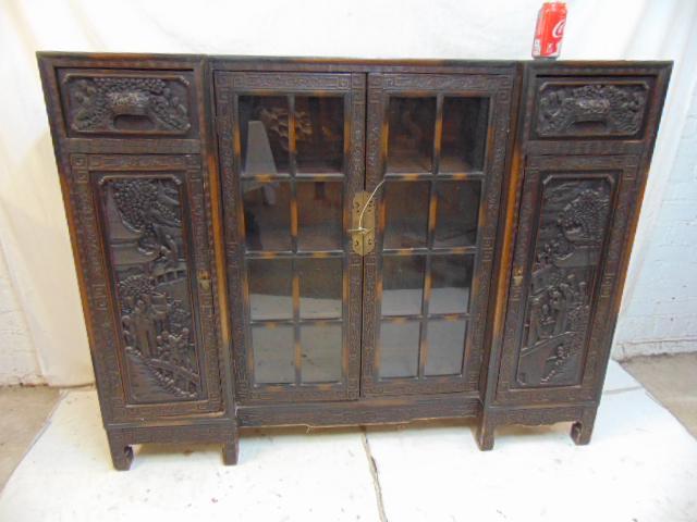 Chinese cabinet, bookcase, carved doors, sides, glass: Chinese cabinet, bookcase, carved doors, sides, glass door center, cabinet is 56" by 11.75", height is 44".