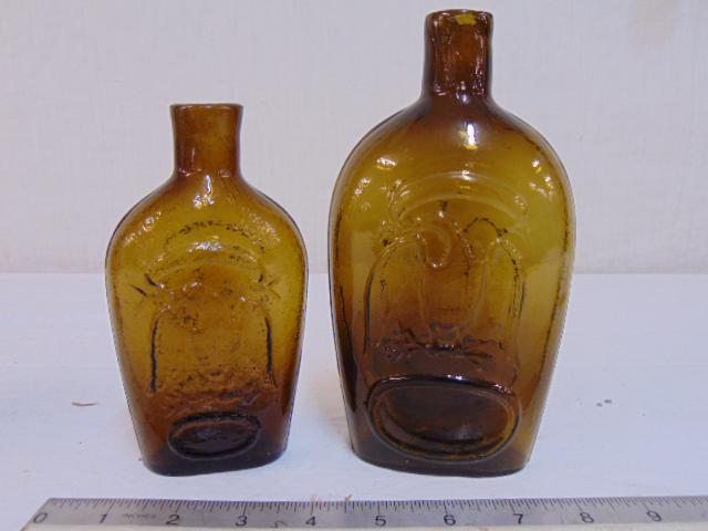 2 amber glass eagle flask bottles, in good condition,6": 2 amber glass eagle flask bottles, in good condition,6" & 7.5"
